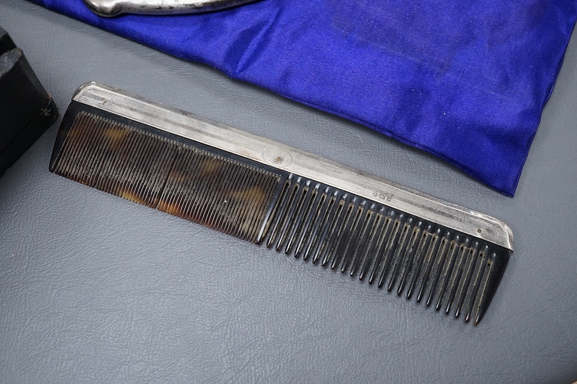 A George V five piece silver and tortoiseshell mounted dressing table set, W G Sothers Ltd, Birmingham, 1926, together with an earlier similar comb, in associated case.